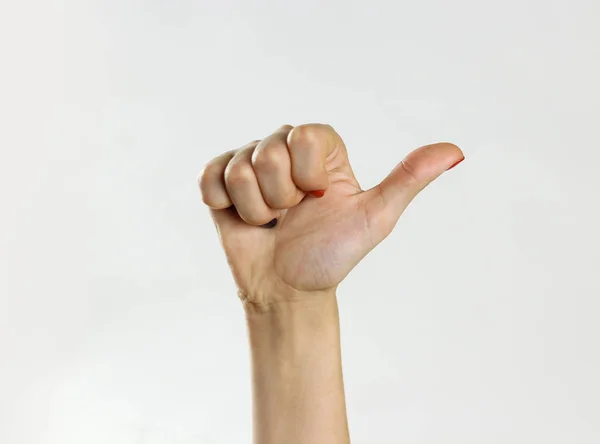 Female hand showing thumb up. Isolated on gray background. Close — Stock Photo, Image