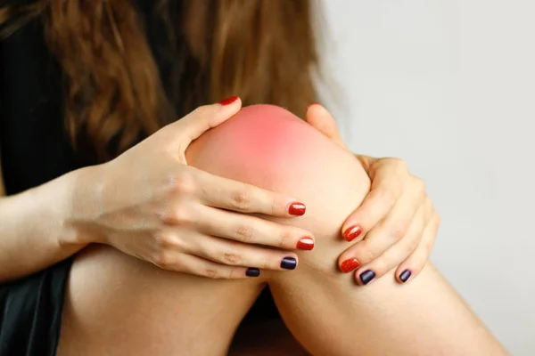 The girl has a pain in his leg. Closeup — Stock Image The girl has a pain in his leg. Closeup Royalty Free Stock Images