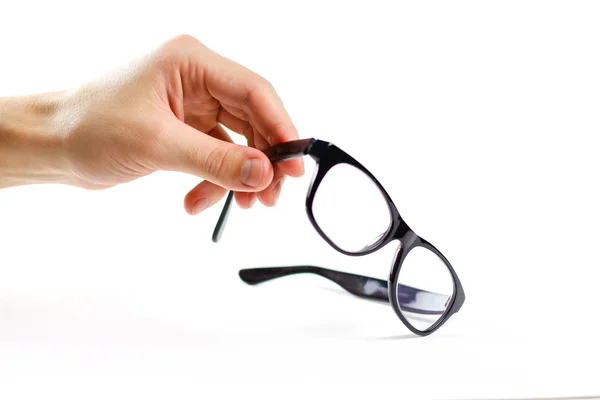 Hand holds transparent glasses for correction of sight. Isolated — Stock Photo, Image
