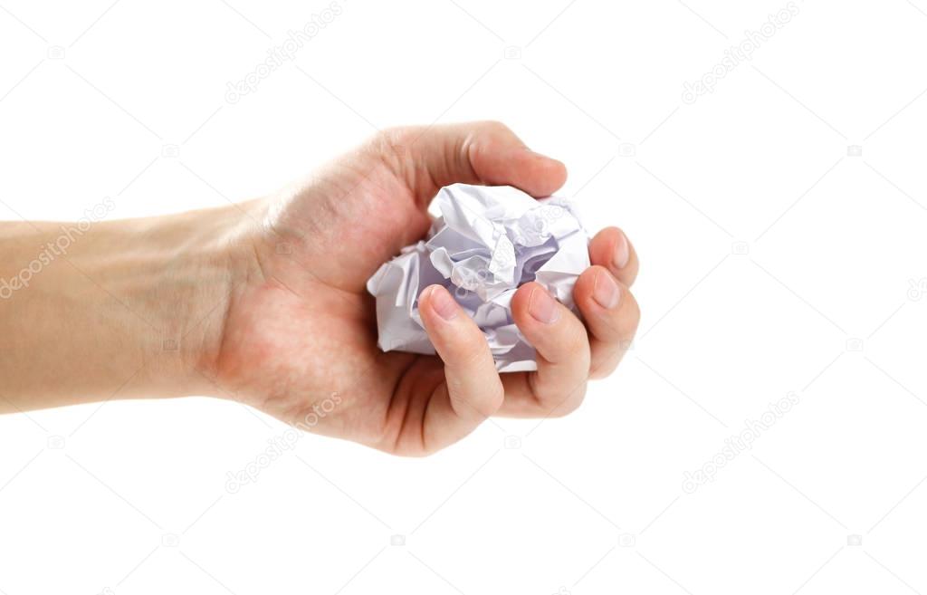 The hand holds a lump of white paper. Isolated on white backgrou