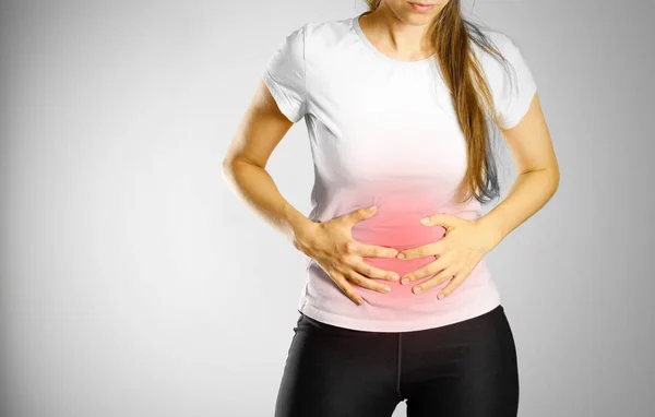 La joven tiene dolor de estómago. Dolor en el abdomen. El dolor — Foto de Stock