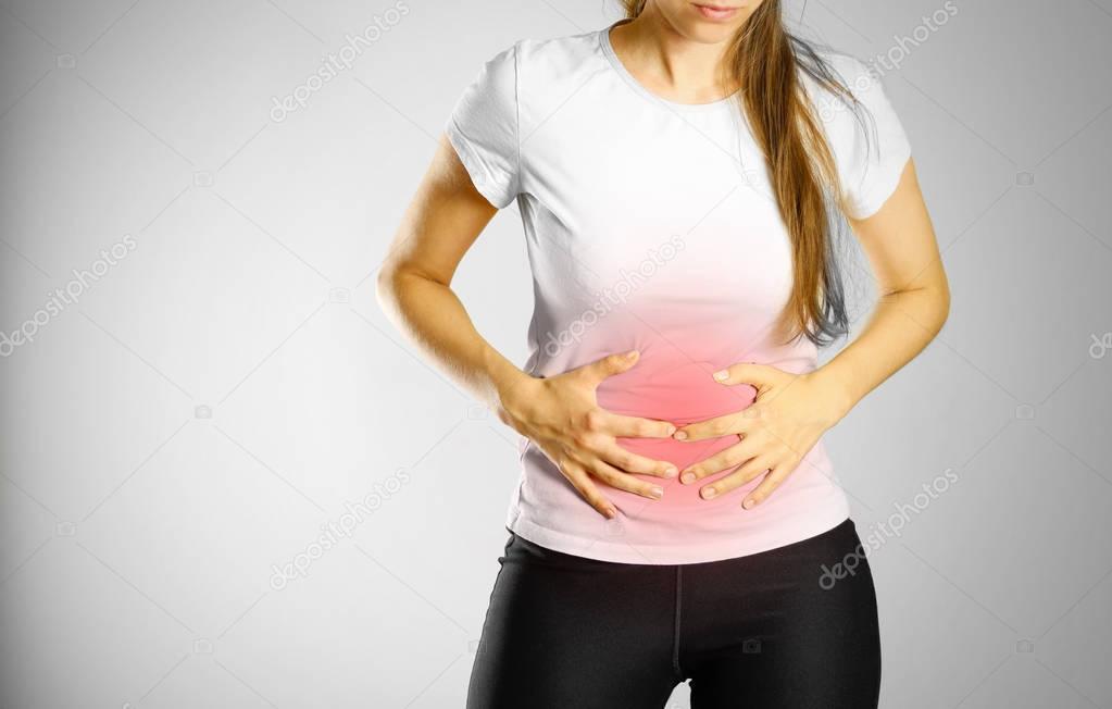 The young girl has a stomach ache. Pain in the abdomen. The pain