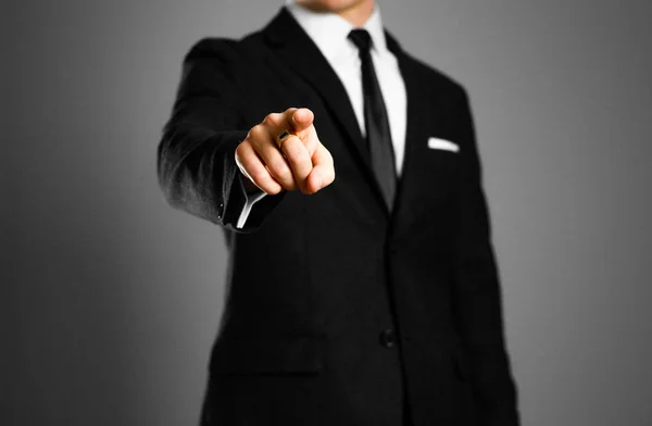 Businessman in a black suit, white shirt and tie pointing the fi — Stock Photo, Image