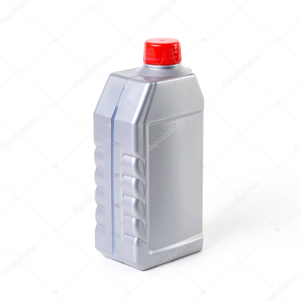 Silvery measuring bottle with red lid. Brake fluid