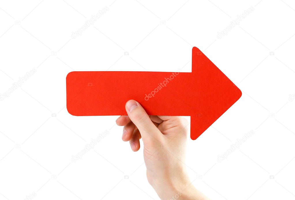 A man's hand holds a large red arrow. Close up. Isolated on a wh