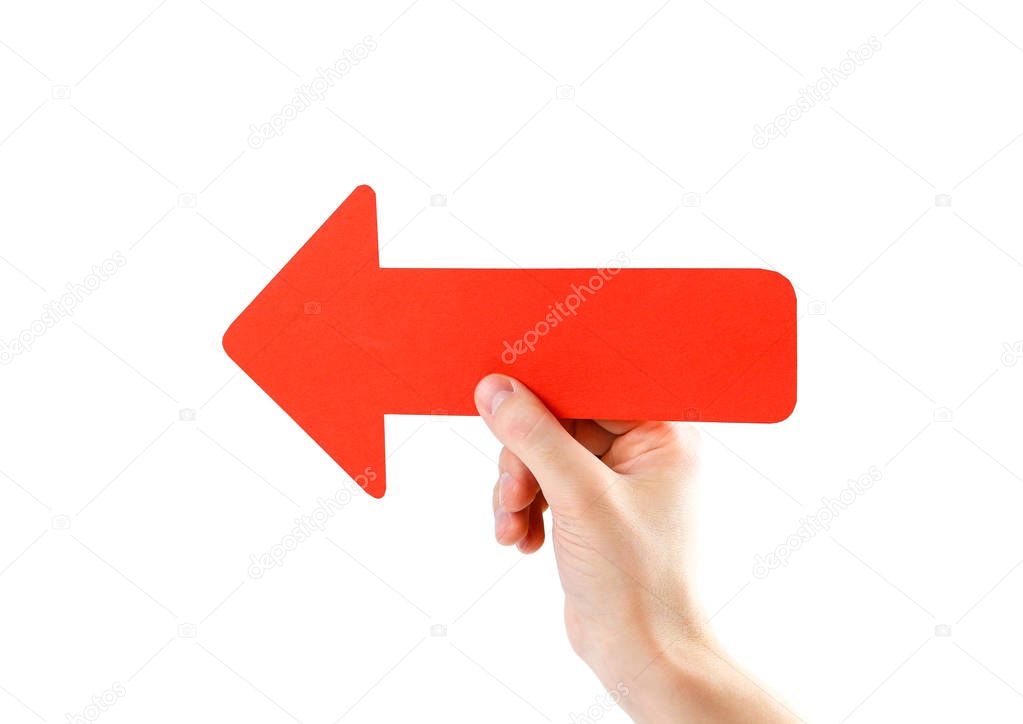 A man's hand holds a large red arrow. Close up. Isolated on a wh