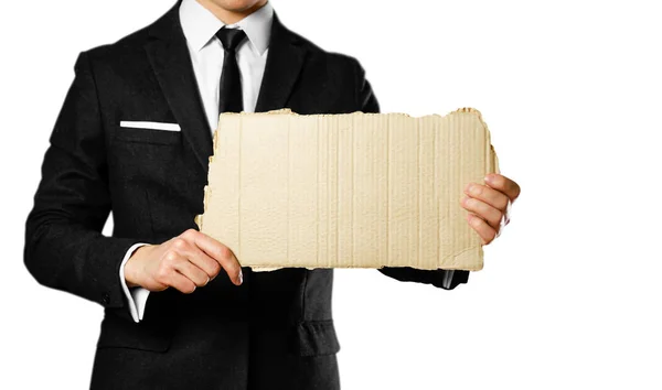 Businessman in a black suit, white shirt and tie holding a piece — Stock Photo, Image