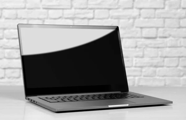 Laptop em uma caixa de metal com uma tela em branco preto. O portátil ligado — Fotografia de Stock