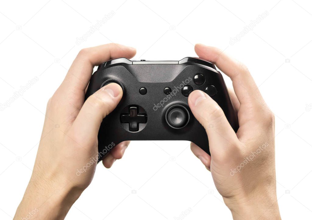 Hands holding a black gamepad for playing computer games. Isolat
