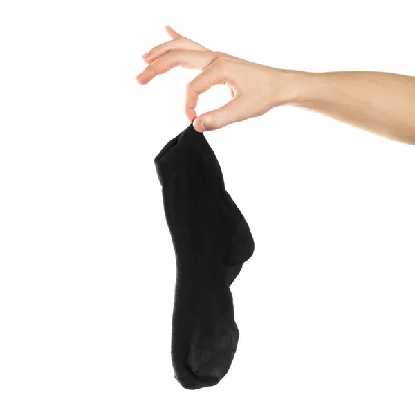 La mano sostiene calcetines sucios y malolientes. De cerca. Aislado sobre una espalda blanca — Foto de Stock