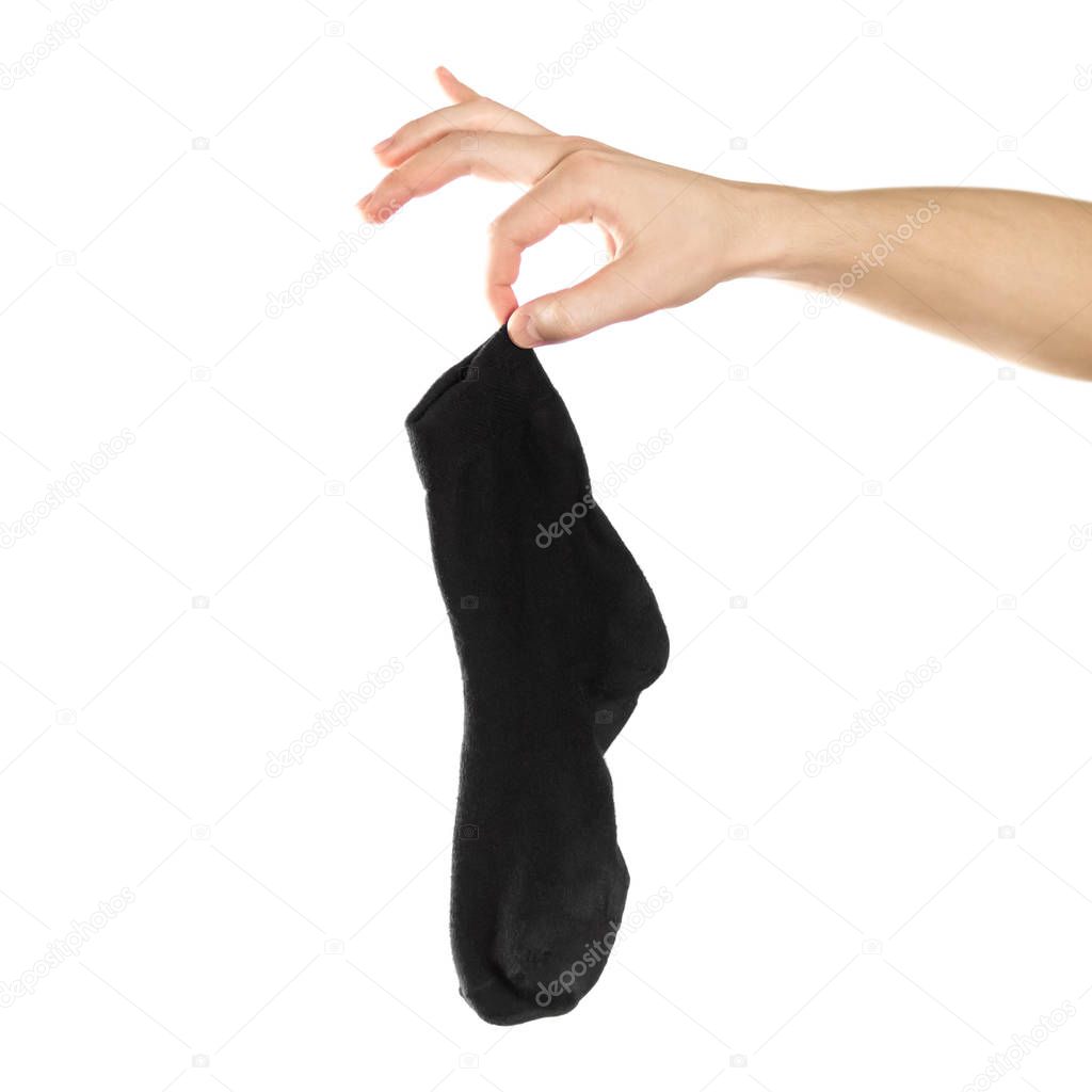 Hand holds dirty smelly sock. Close up. Isolated on a white back