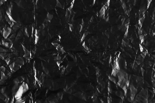 Texture of a black crumpled plastic bag. Close up — Stock Photo, Image