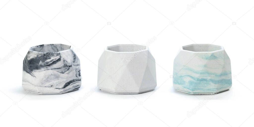 Faceted concrete candle holders. Close up. Isolated on a white background.