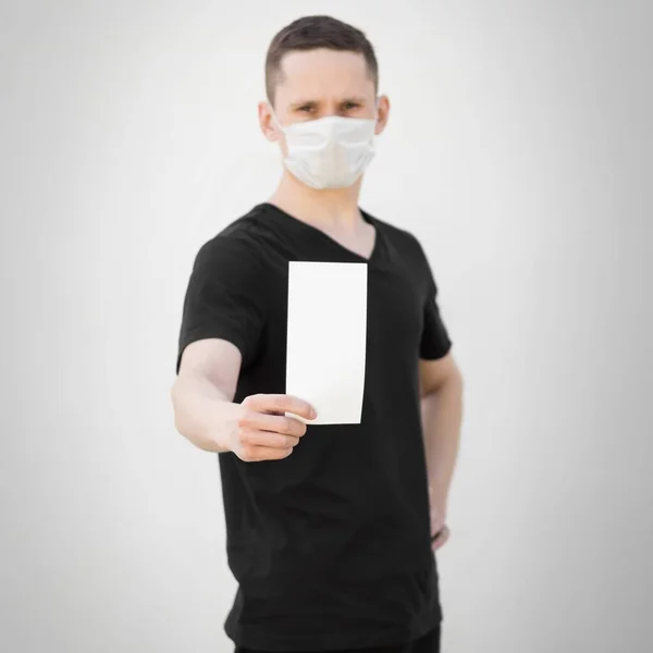 Man Medical Mask Holds Blank White Sheet Paper Close Isolated — Stock Photo, Image