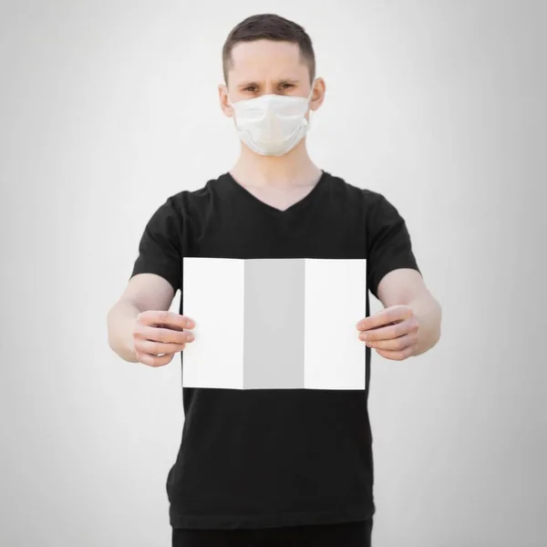 Man Medical Mask Holds Blank White Sheet Paper Close Isolated — Stock Photo, Image