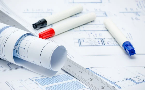 Rolled architectual plans with marker pens and ruler Stock Photo