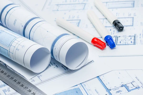 Rolled architectual plans with marker pens and ruler Stock Image