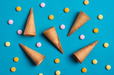 Dondurma koniler ve tatlılar mavi arka plan üzerinde.