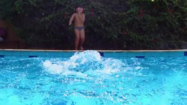 Ein Kleiner Junge Der Einen Pool Springt Und Spaß Beim — Stockvideo