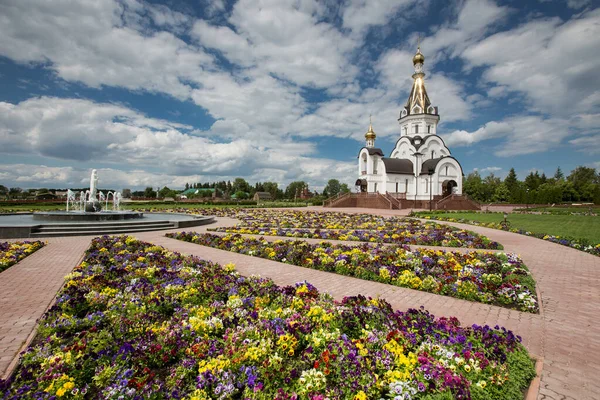 Ortodoks Kilisesi 'nin güzel manzarası, çiçekler ve mavi gökyüzü.