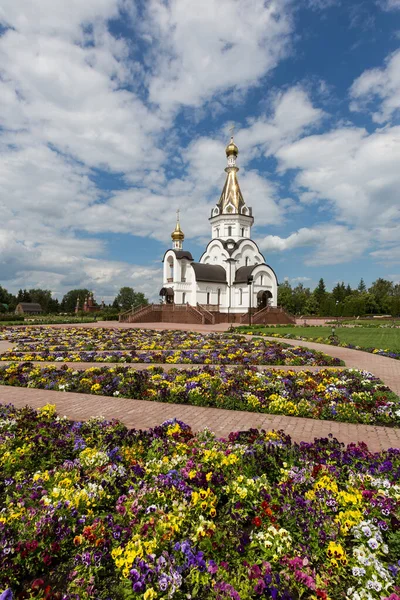 Beautiful view of the Orthodox Church, flowers and blue sky.