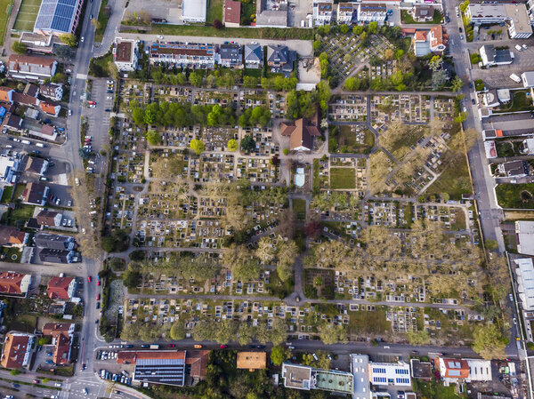 Top view of the city cemetery in Viernheim. Rows of graves. Gray trees. Germany.
