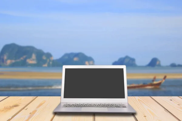 Laptop with blank screen on wooden table with lake and sea — Stock Photo, Image