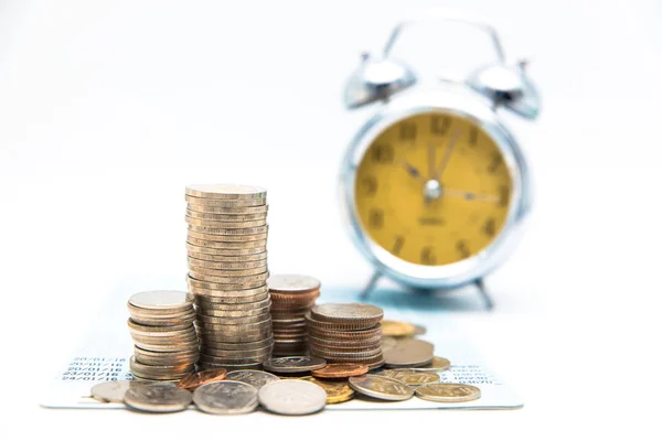 Stack of coins with vintage clock on white background for mocup — Stock Photo, Image