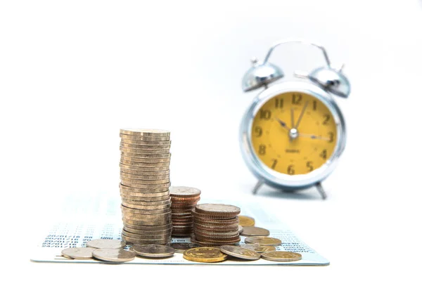 Stack of coins with vintage clock on white background for mocup — Stock Photo, Image