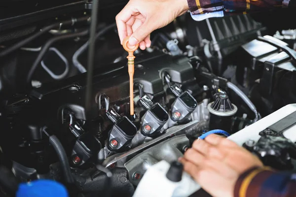 Fermez les mains en vérifiant le niveau d'huile de lubrifiant du moteur de voiture des profondeurs — Photo