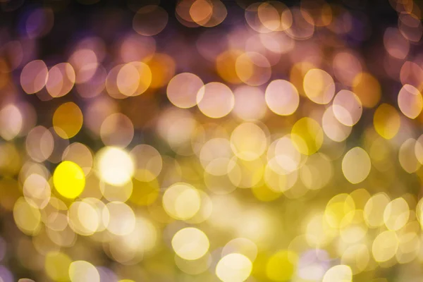 Gold and purple abstract bokeh or defocused background glitterin