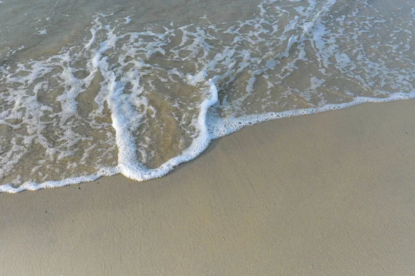 Top View on waves on beach aerial view, crystal clear water with beautiful foam.