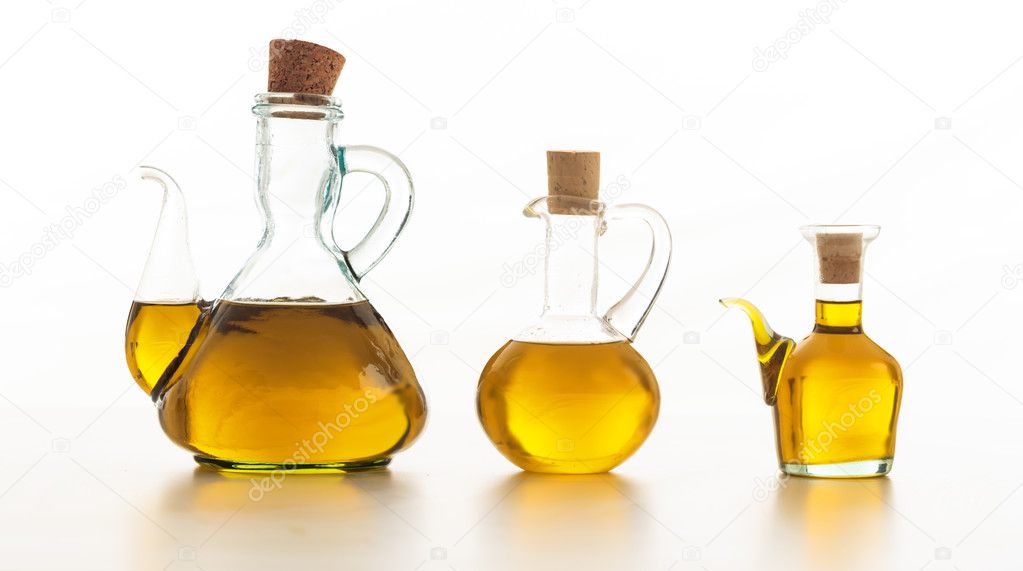 Set of bottles of olive oil on white background