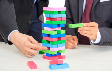 Tahta bloklar oyunu oynarken işadamları 