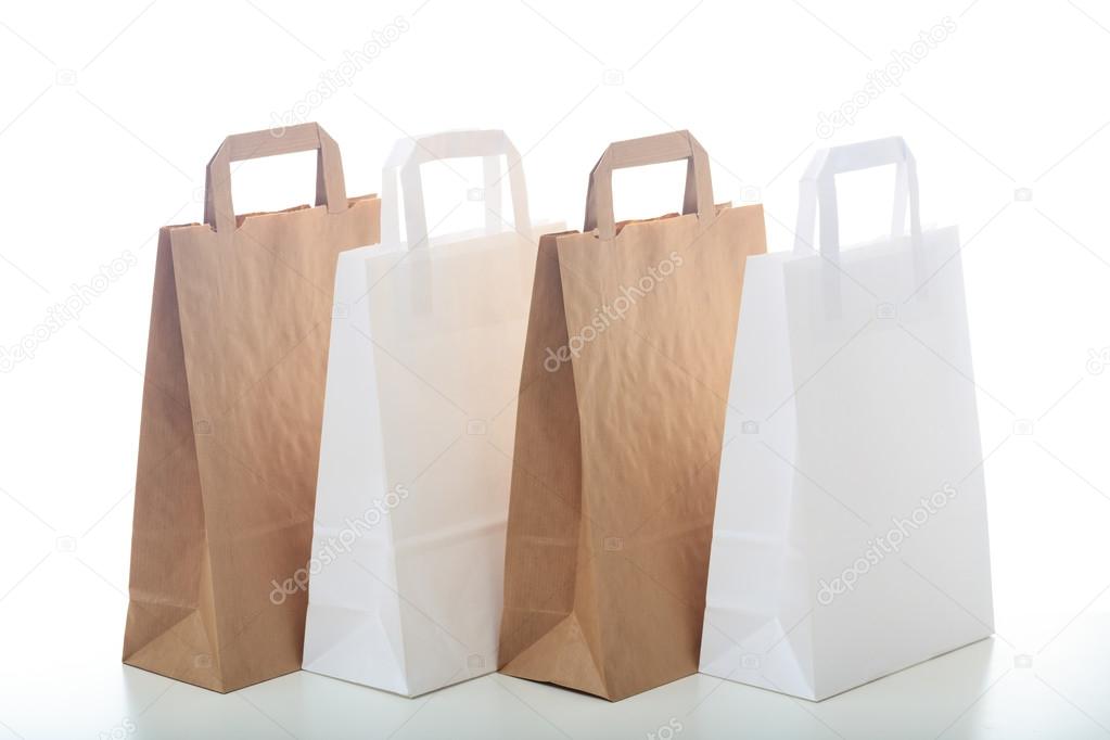 Brown and white paper shopping bags on white background