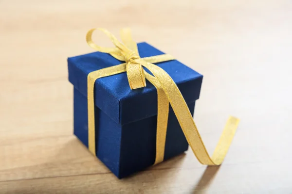 Gift box on wooden background Stock Image