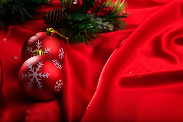 Christmas balls on red satin — Stock Photo, Image