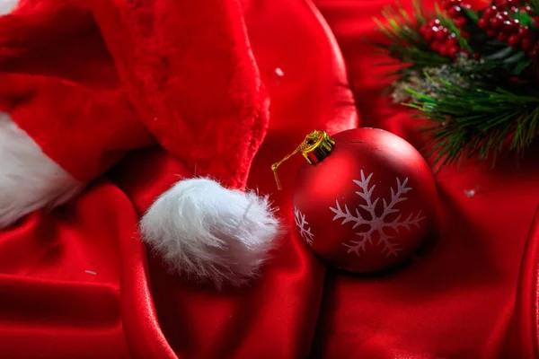 Christmas ball on red satin — Stock Photo, Image