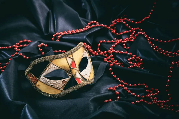 Carnaval masker op zwarte satijnen achtergrond — Stockfoto