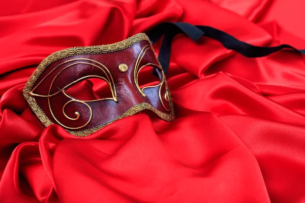Carnival mask on red satin background — Stock Photo, Image