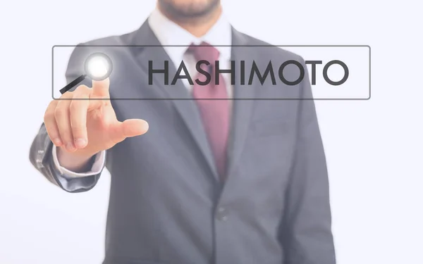 Mann zeigt auf Wort hashimoto — Stockfoto