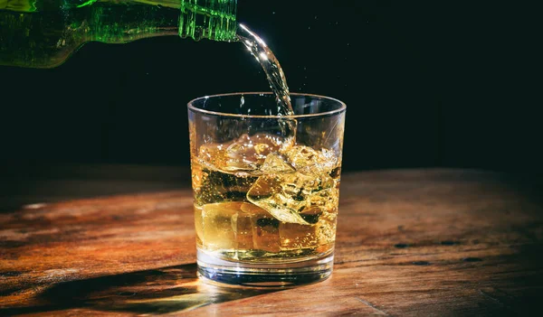Pouring whiskey in a glass — Stock Photo, Image