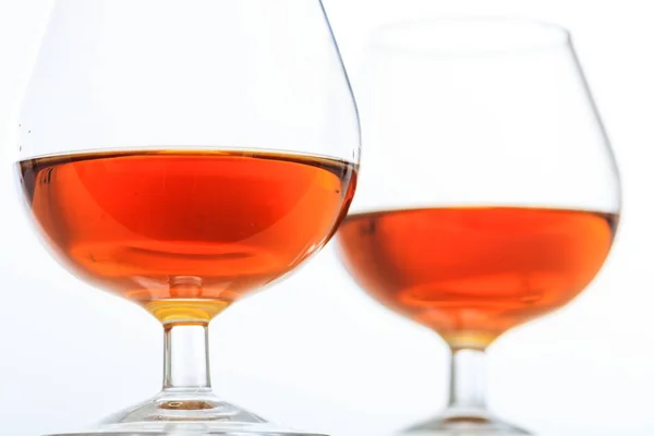Two cognac glasses on white background Royalty Free Stock Photos