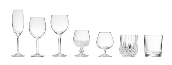 Variety of empty glasses on white background