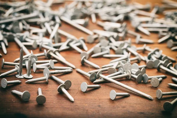 Clavos sobre fondo de madera — Foto de Stock