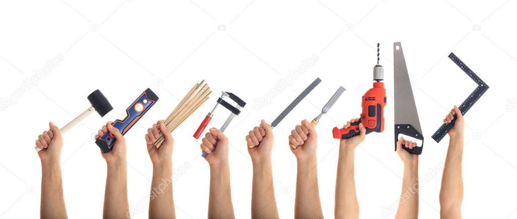 Hands holding tools on white background