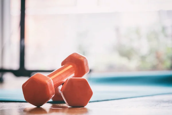 Pair of dumbbells on a wooden floor — Stock Photo, Image