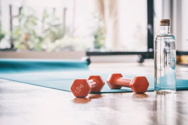 Pair of dumbbells on a wooden floor — Stock Photo, Image