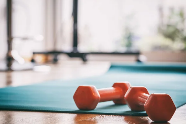 Pair of dumbbells on a wooden floor — Stock Photo, Image