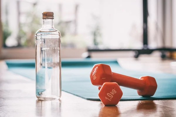 Pair of dumbbells on a wooden floor — Stock Photo, Image